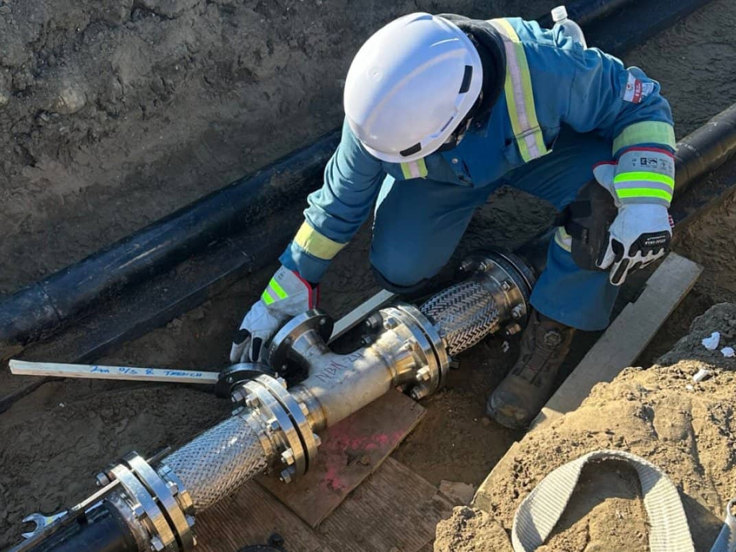 Technician assembling an underground fire water utility pipe