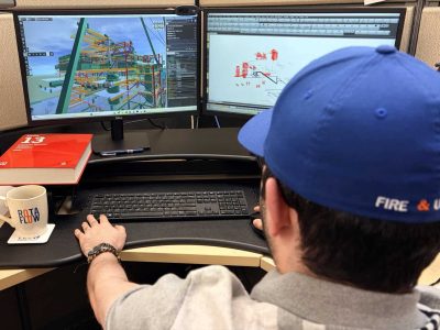 Rotaflow engineer designing a fire alarm and sprinkler system in 3D modeling software with the NFPA 13 handbook