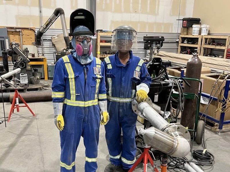 Rotaflow team members in safety gear at the fabrication shop